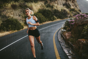 Female athlete running along the highway