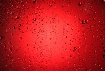 Drops on the glass with a red glow