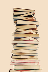 High stack of books on light background