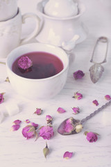 Fototapeta na wymiar Tea set and rose tea on table