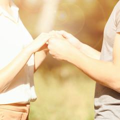 Couple holding hands, close up