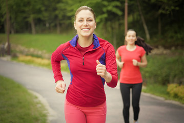 Smiling friends running outdoors. 