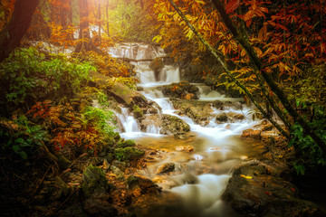 Waterfall in deep forest in autumn