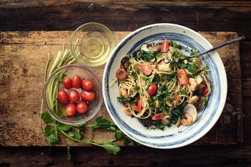 Top view of Seafood spaghetti on rustic wooden board