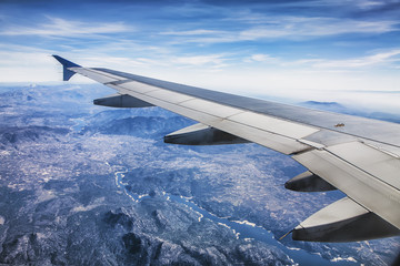 Obraz premium Ala de avión volando sobre un rio
