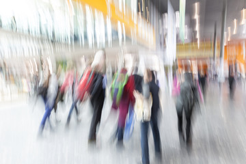 People stream in modern interior, motion blur