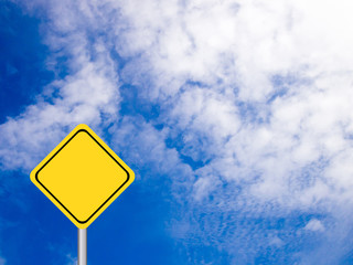 Blank yellow transportation sign on clear blue sky with white cl