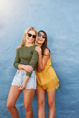 Two beautiful happy friends in sunglasses