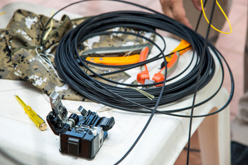 Cleaver optic fiber with pliers and dropwire fiber optic on whit