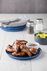 Teriyaki chicken wings serves with noodles and sauce