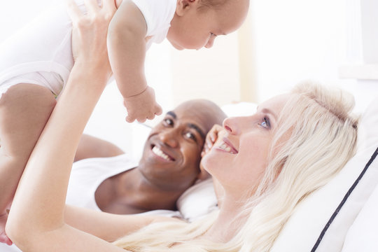 Cheerful interracial family cuddling for global family day
