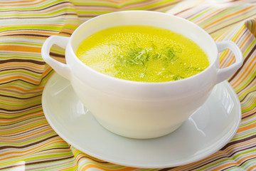 Clear soup in a white bowl