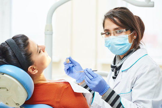 Female Asian Dentist Doctor At Work