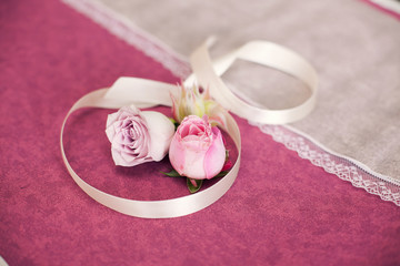 Rose with ribbon on a lilac background.