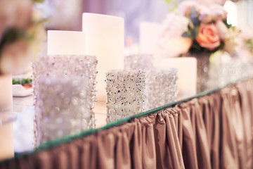 Naklejka na ściany i meble beautiful decorative brilliant candles on a wedding table