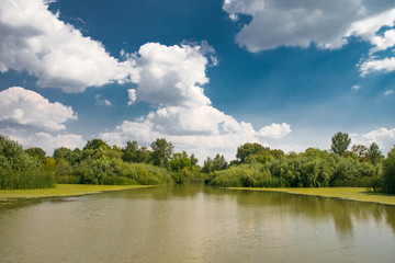 Landscape, blue sky over calm lake