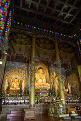 Obraz premium Tall Dharma Hall and three golden Buddha statues inside the Yakchunsa (Yakcheonsa) Temple on Jeju Island in South Korea.