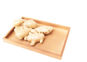 Closeup top view ginger on wooden tray with white background