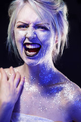 Portrait of screaming woman. Bright neon fashion makeup, creative body art.