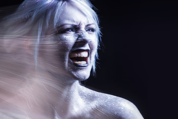 Portrait screaming woman. Bright neon fashion makeup, creative body art. Effect of movement