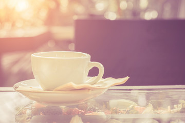 Fototapeta premium Cup of coffee on table in cafe,White cup of coffee at the cafe interior on the morning.