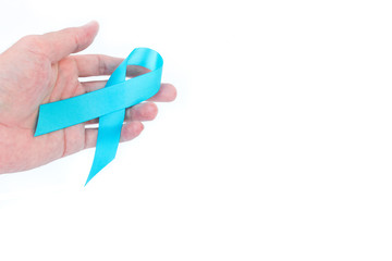 Hand hold blue ribbon on white background prostate cancer awareness concept