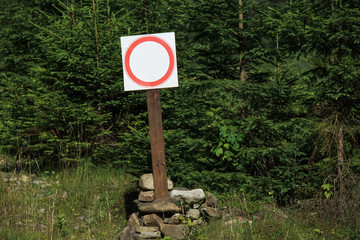 Stop sign in beautiful nature background. Horizontal photo of blank prohibition sign and mountain...