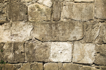 Stone wall texture of gray and brown colors. Horizontal color photo.