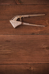 masher for garlic on a wooden background