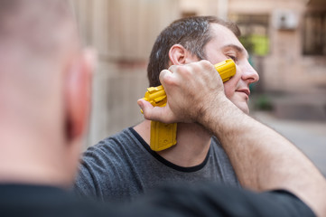 Kapap instructor demonstrates self defense techniques against a gun point. Gun Disarm.