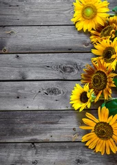 Fotobehang Old wooden background with sunflowers. © perikatipole