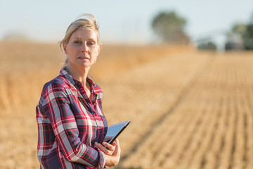 Female farmer using digital tablet in the wheat field
