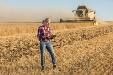 female farmer standing in wheat field