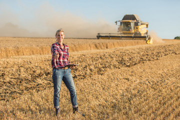female farmer standing in wheat field