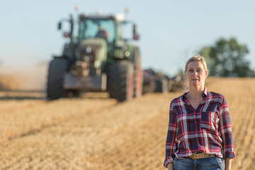 female farmer standing in wheat field