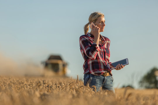 Female Farmer Walking Through Field Checking Wheat Crop