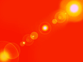 Lens flare in yellow and white on an orange background