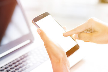 Close Up of woman's hands using mobile phone and coffee with blank copy space screen for your advertising text message or content, in the morning light.