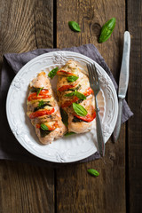 Baked chicken breast with mozzarella and cherry tomatoes with basil