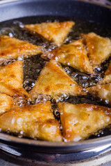 Chicken samosas deep fried.