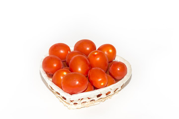 A basket of fresh red tomatoes,  isolated on white