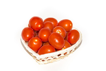 A basket of fresh red tomatoes,  isolated on white