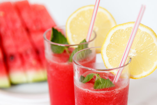 fresh sliced watermelon and watermelon smoothie on a wooden table. close up. Selective focus
