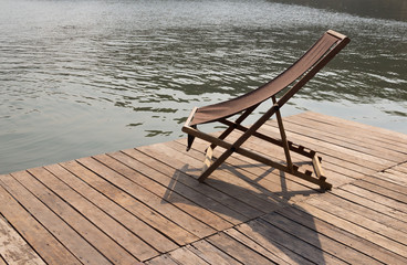Fototapeta na wymiar chaise longue on a raft River side