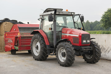 Red tractor with red cattle feed diffuser.