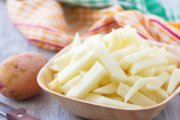 Raw sliced potatoes in a bowl