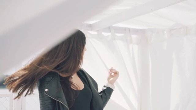 Passionate girl posing and looking on camera on white gazebo background 4K