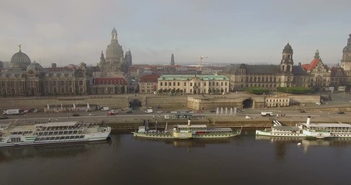 Aerial camera moves slowly across the River Elbe towards the Frauenkirche in Dresden