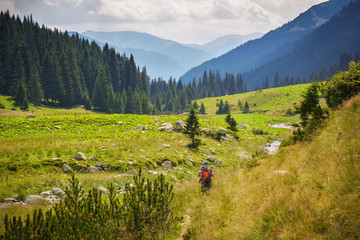 Man backpacker walking in the middle of nature, Retezat National Park, Romania