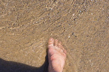 High angle of female foot in sea water